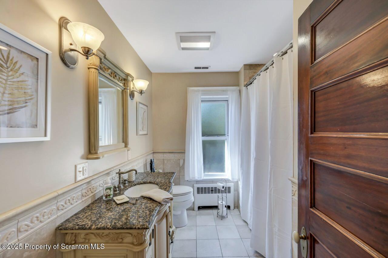 1118 Columbia Street Scranton, PA 18509 - Photo 64 of 92 a bathroom with a granite countertop sink and a mirror