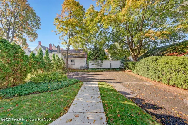 a living room with furniture a dining table and a chandelier