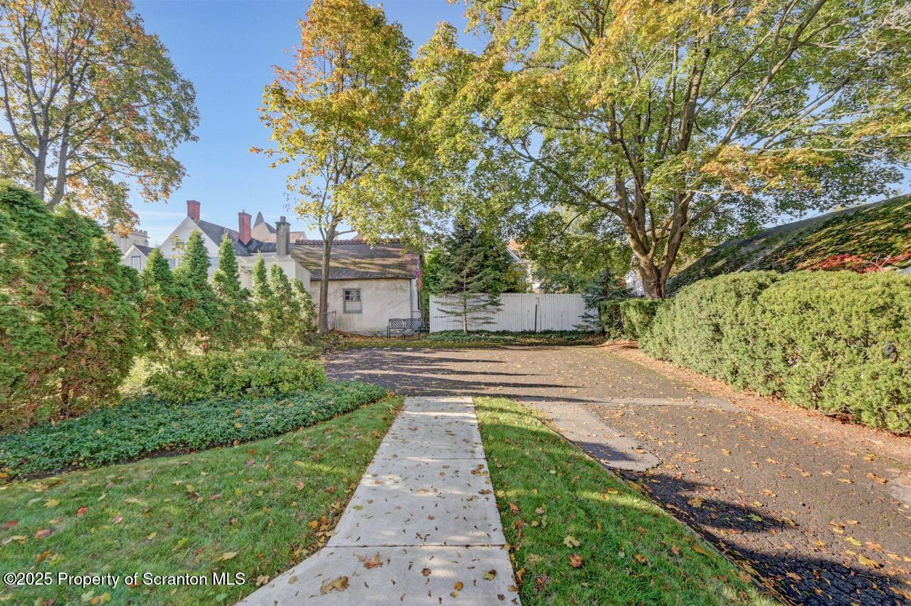 1118 Columbia Street Scranton, PA 18509 - Photo 8 of 92 a front view of a house with a yard and fountain in middle