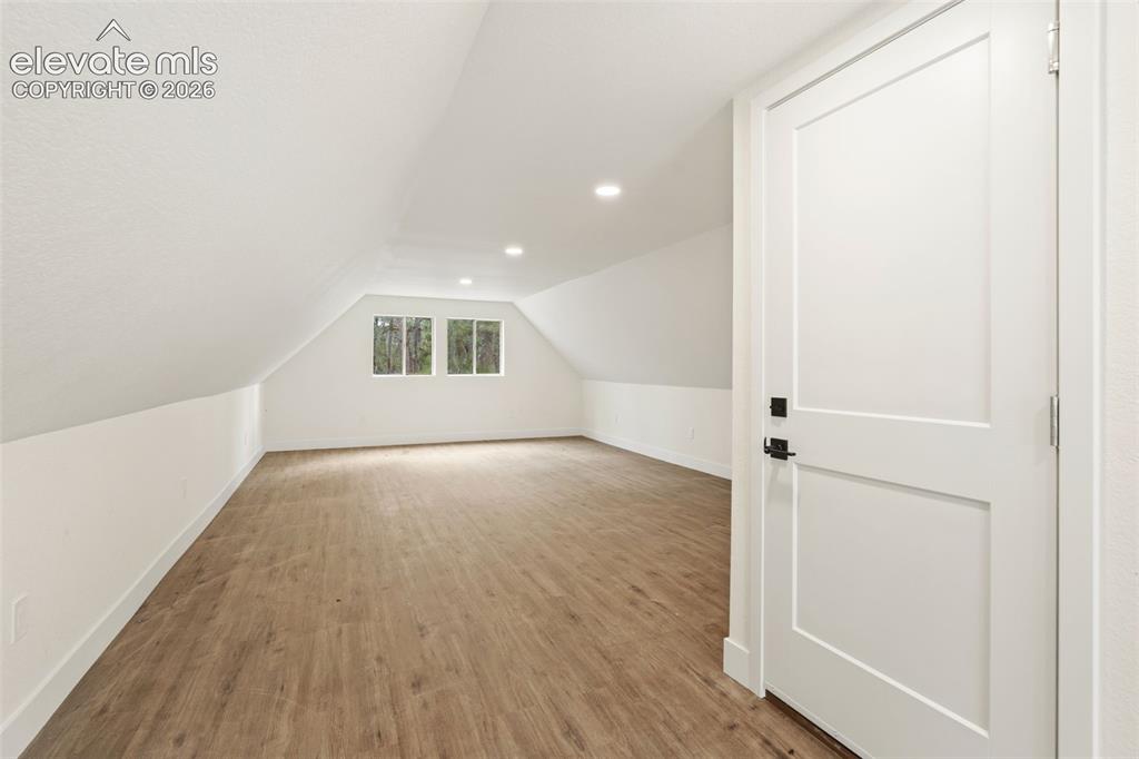 11665 Greentree Road Colorado Springs, CO 80908 - Photo 39 of 43 Bonus room featuring light wood-style floors, vaulted ceiling, and recessed lighting