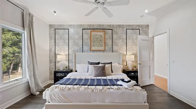 a spacious bedroom with a bed and glass window