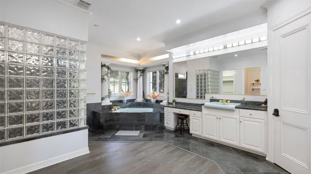 a large white kitchen with a large window