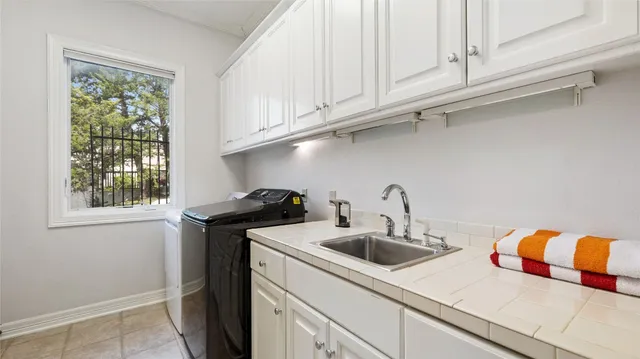 a kitchen with stainless steel appliances granite countertop a sink a stove and a white cabinets