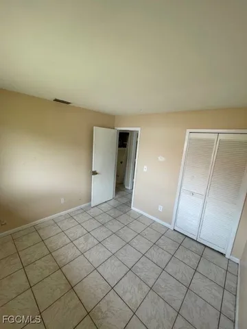 a view of an empty room and wooden floor