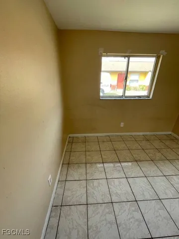 a kitchen with granite countertop a sink stove and cabinets