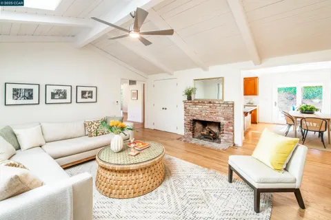 a living room with furniture a fireplace and a table