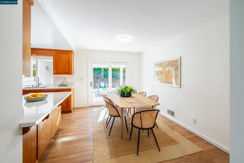 a view of a kitchen area with furniture and wooden floor