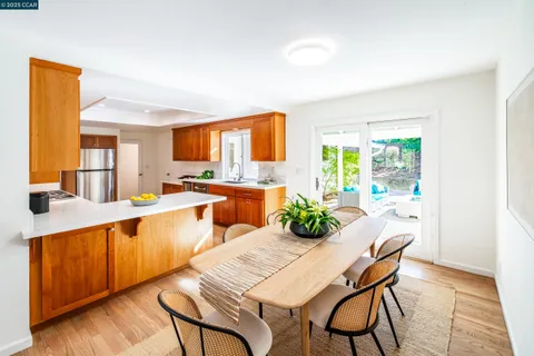 a large kitchen with a table and chairs in it