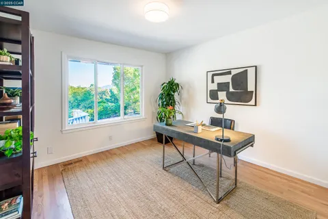 a work room with furniture and a potted plant