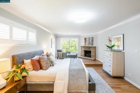 a view of a bedroom with furniture and a fireplace