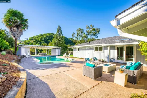 a front view of a house with a yard and outdoor seating