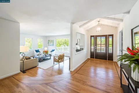 a living room with furniture or wooden floor and a large window