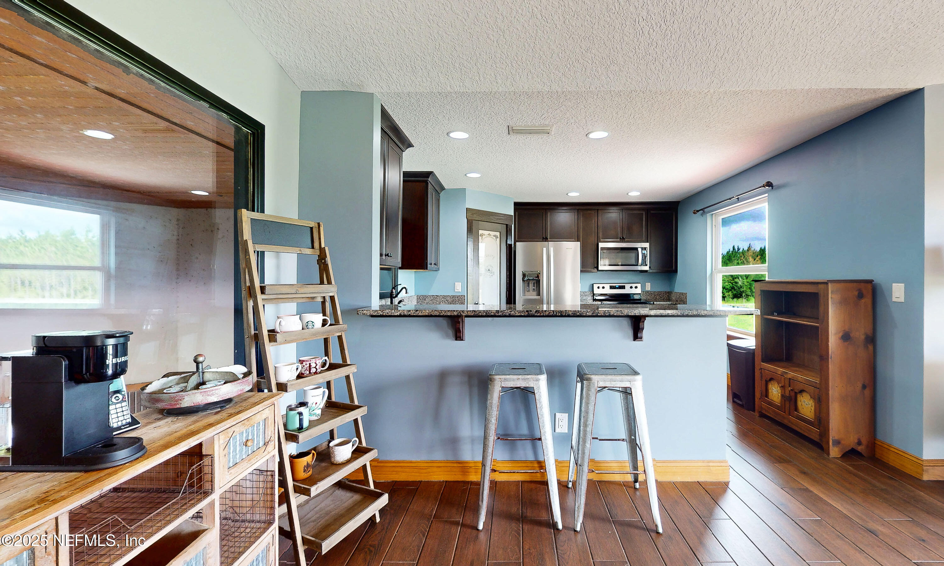 1845 Kinard Road Bryceville, FL 32009 - Photo 25 of 86 a kitchen with stainless steel appliances granite countertop a refrigerator sink and cabinets
