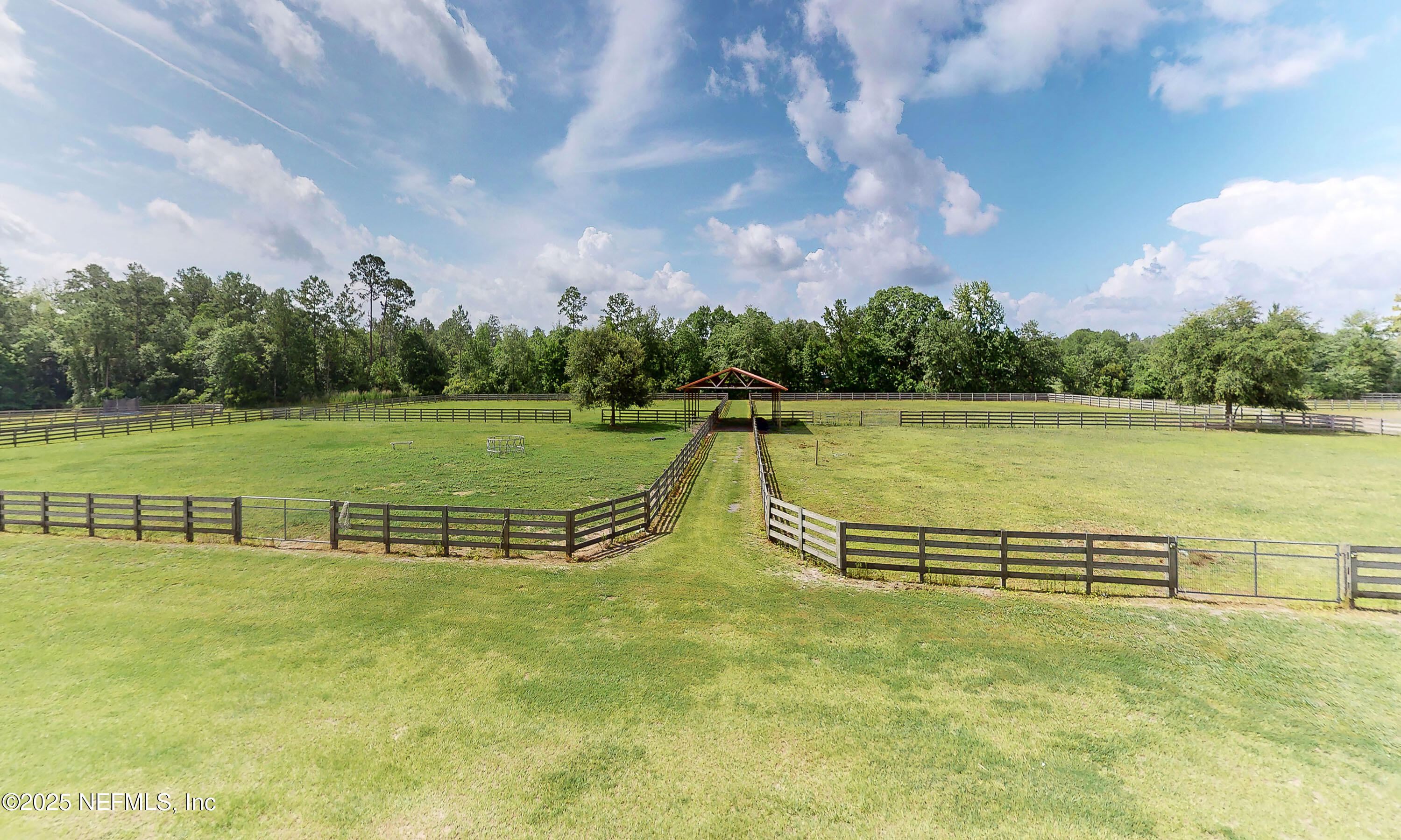 1845 Kinard Road Bryceville, FL 32009 - Photo 33 of 86 a view of a lake with a yard and a large tree