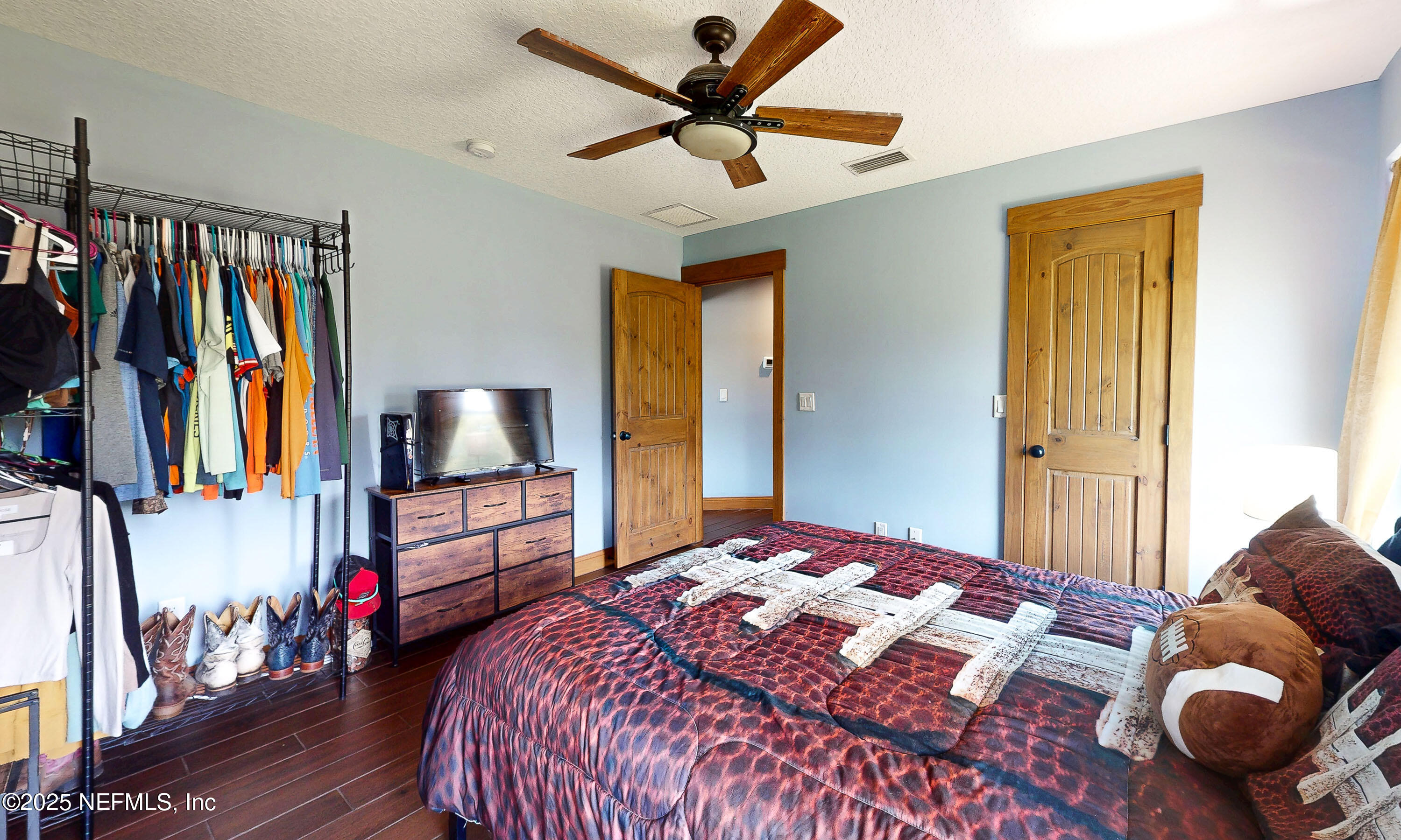 1845 Kinard Road Bryceville, FL 32009 - Photo 37 of 86 a bedroom with a bed and a flat screen tv