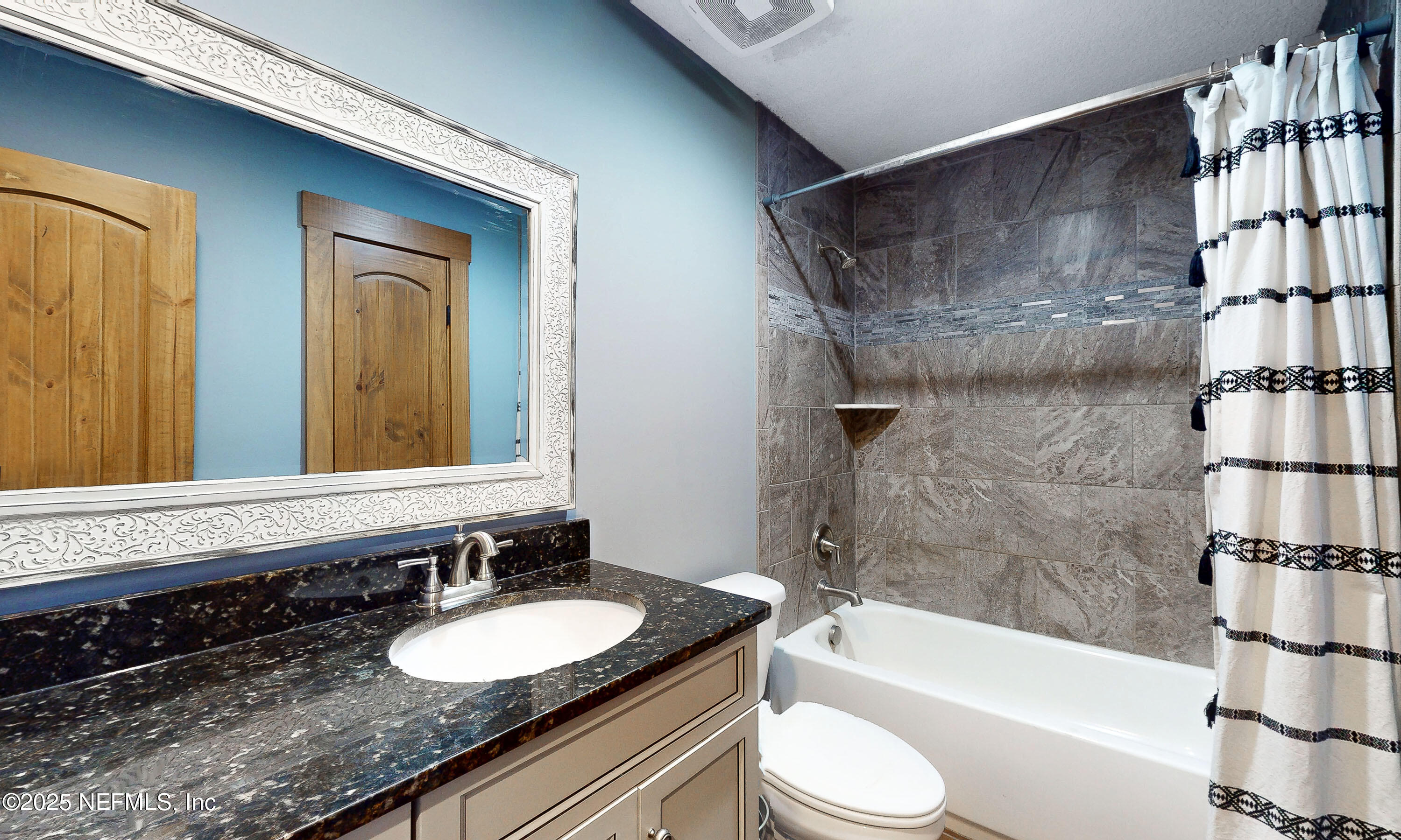 1845 Kinard Road Bryceville, FL 32009 - Photo 38 of 86 a bathroom with a granite countertop sink toilet and shower