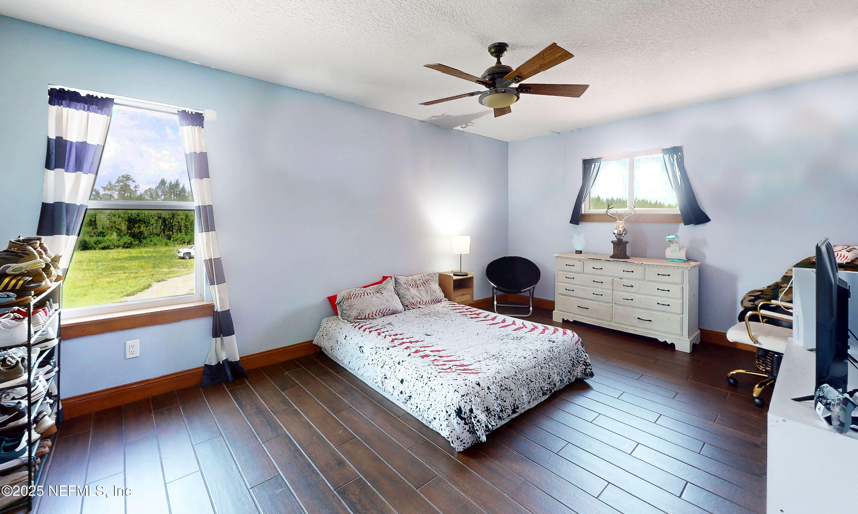 1845 Kinard Road Bryceville, FL 32009 - Photo 39 of 86 a bedroom with a bed a dresser and a window