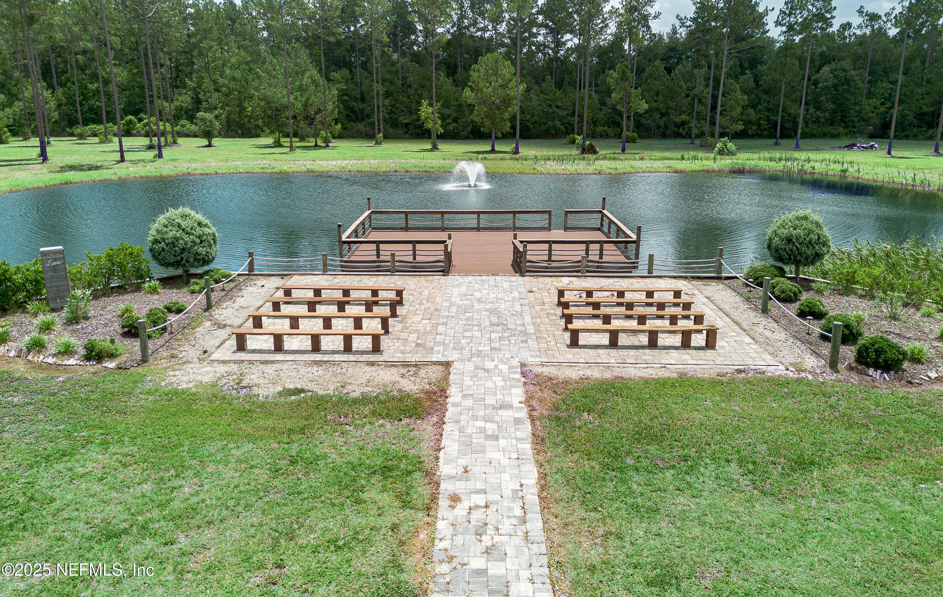 1845 Kinard Road Bryceville, FL 32009 - Photo 10 of 86 a view of a lake with a yard and large trees