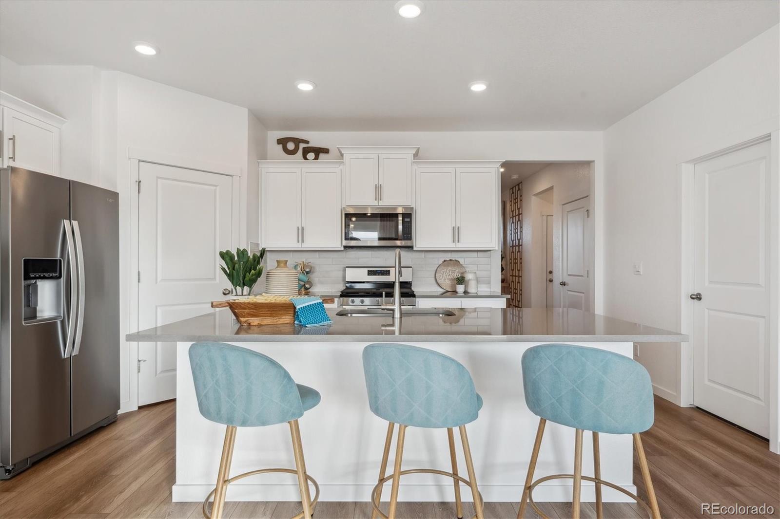 2226 Base Street Fort Lupton, CO 80621 - Photo 15 of 28 a kitchen with stainless steel appliances granite countertop a refrigerator and a stove top oven