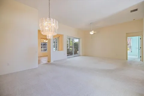 a view of a livingroom with a ceiling fan and window