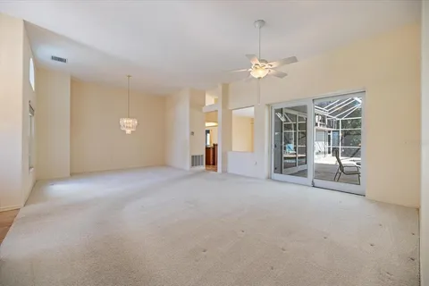 en empty room with windows and fan