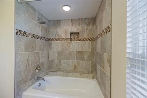 a bathroom with a granite countertop sink mirror vanity and toilet