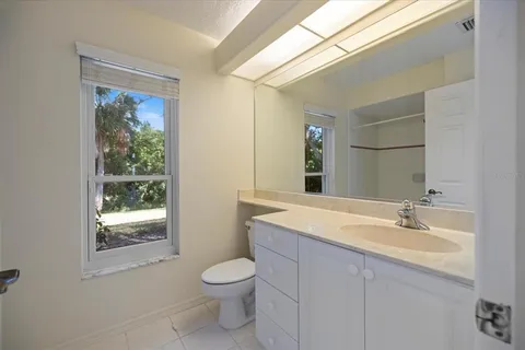 an empty room with a ceiling fan and window