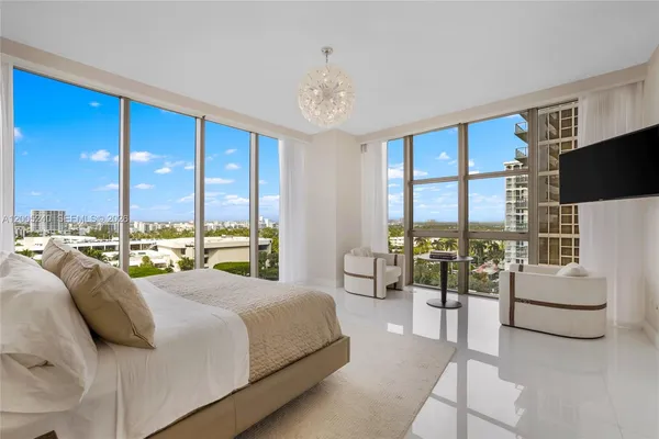 a bedroom with a bed and a chandelier