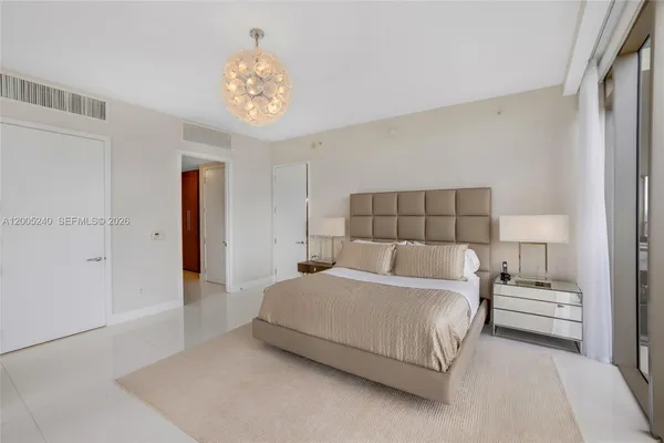 a bedroom with a bed and a night stand
