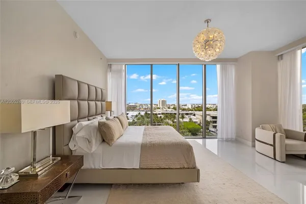 a bedroom with a bed and a chandelier
