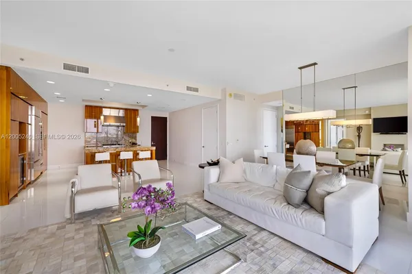 a view of a livingroom with furniture and a flat screen tv