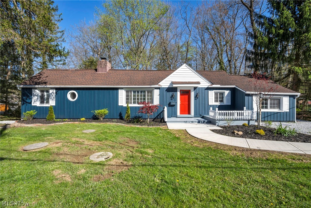 7339 River Road Olmsted Falls, OH 44138 - Photo 2 of 45 Exterior featuring blue vertical siding, white trim, and a prominent red front door
