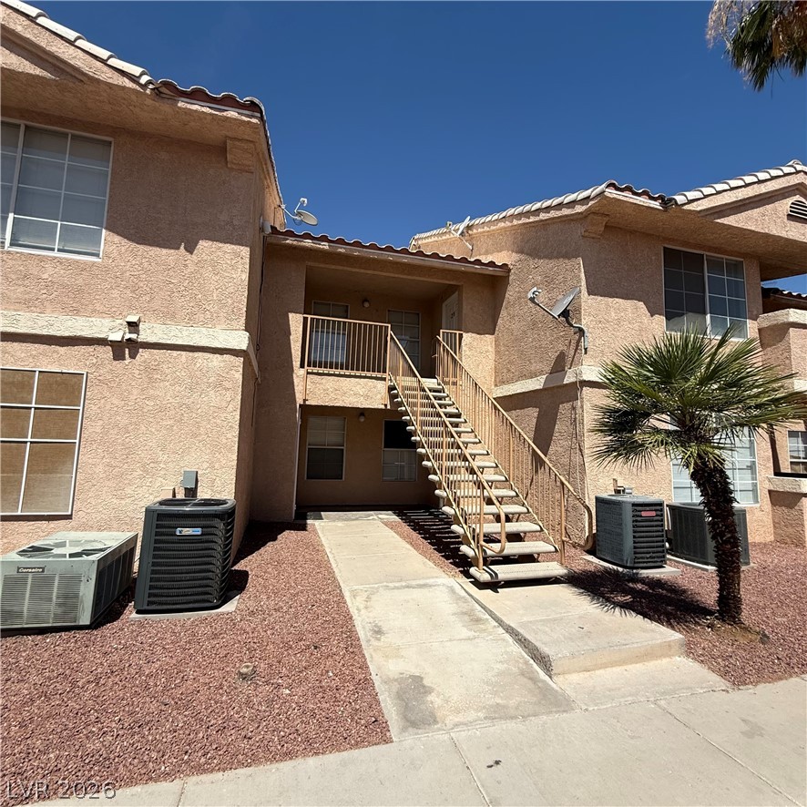 1830 North Pecos Road, Unit 258 Las Vegas, NV 89115 - Photo 1 of 14 A well-maintained stucco exterior features a tile roof and convenient exterior staircase access to upper units.