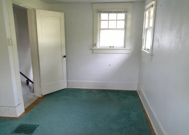 an empty room with a empty space and window