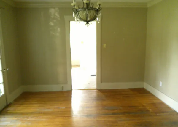 a view of a room with wooden floor