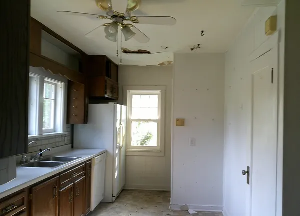 a kitchen with a sink appliances and cabinets