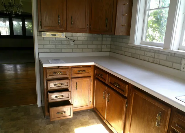 a kitchen with granite countertop cabinets and window
