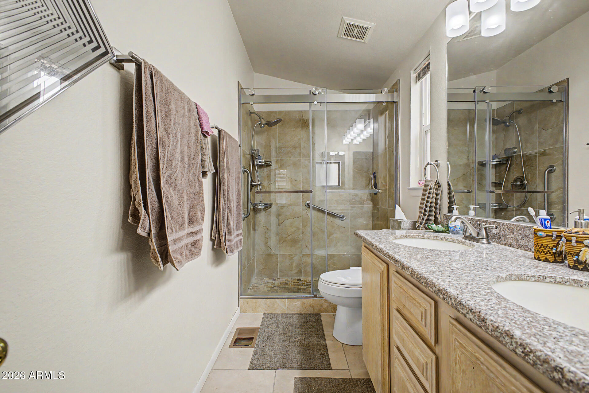 2101 South Meridian Road, Unit 45 Apache Junction, AZ 85120 - Photo 18 of 36 a bathroom with a granite countertop sink a toilet a mirror and shower
