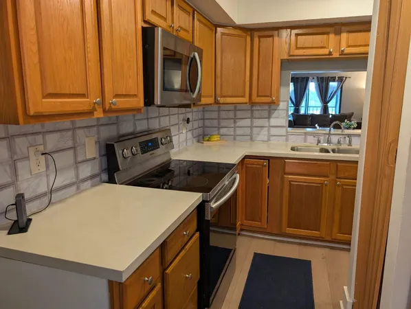 a kitchen with stainless steel appliances a sink and cabinets