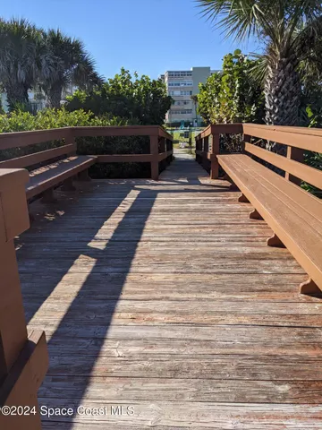 a view of balcony with wooden floor and outdoor seating