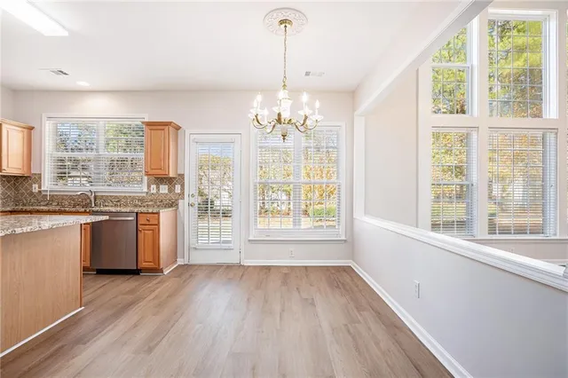 a view of a kitchen with granite countertop a stove and a large window