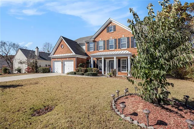 a front view of a house with a yard covered with snow in front of house