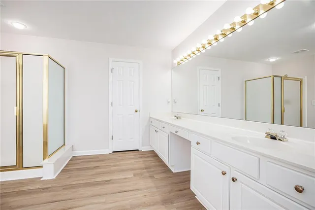 a spacious bathroom with a double vanity sink and a mirror
