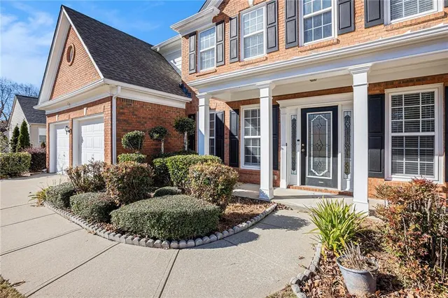 a view of a house with potted plants