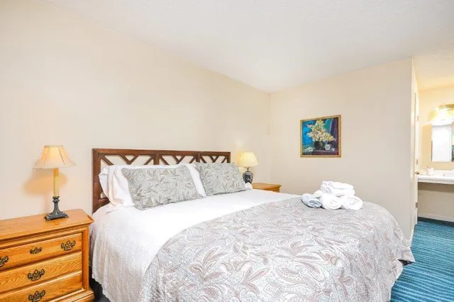 a bedroom with a bed and a night stand