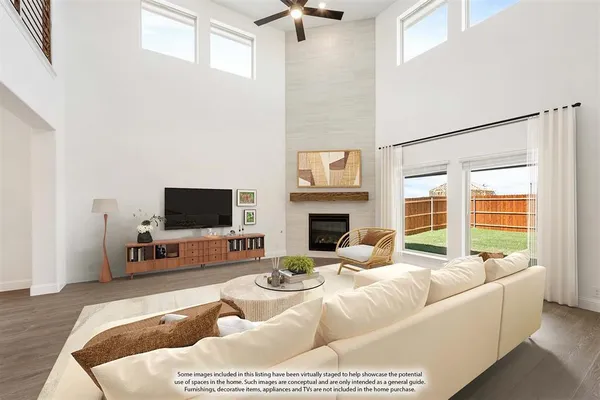 a living room with furniture a fireplace and a flat screen tv