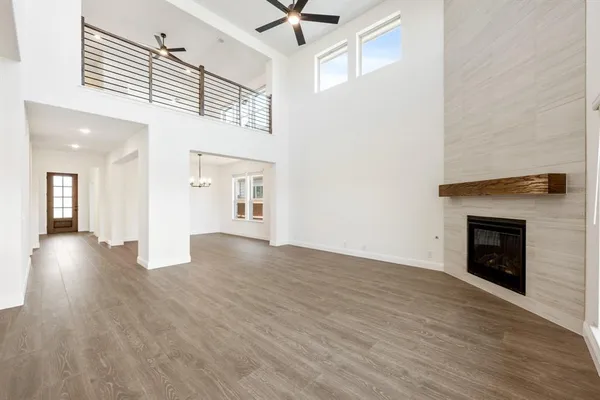 a view of a livingroom with wooden floor and a fireplace