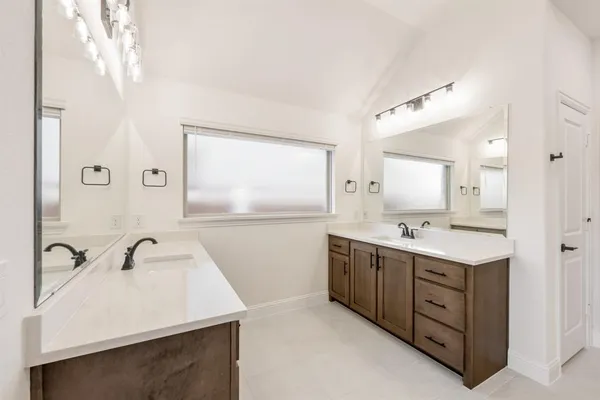 a bathroom with a double vanity sink and mirror