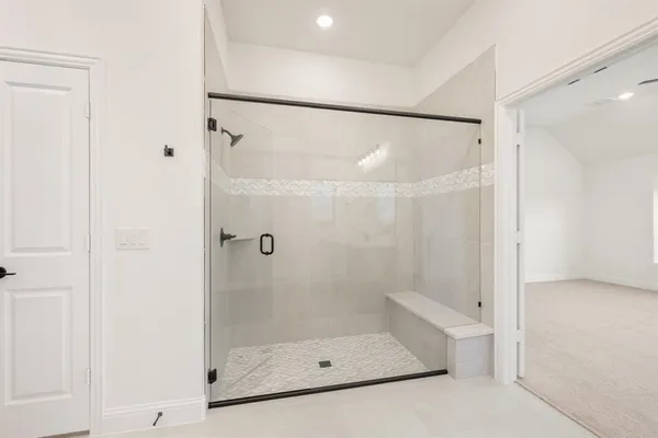 a bathroom with a glass shower door