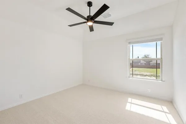 an empty room with a window and a fan